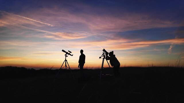 Amateur astronomers looking at the evening skies, observing planets, stars, Moon and other celestial objects with a telescope and camera on a star tracker.