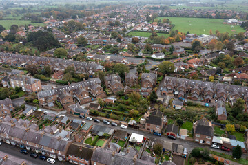 Aerial drone photo of the market town of Thirsk in North Yorkshire, England showing rows of victorian terrace houses and homes on a gloomy dark bad weather rainy day in the winter time © Duncan