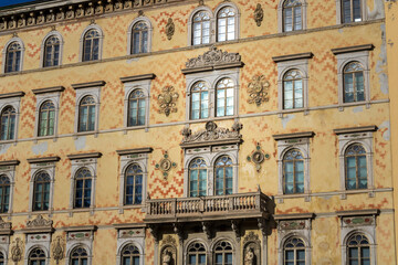ornate historic building facade with arched windows and balcony