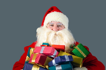 Portrait of Santa Claus holding gifts for children.  Christmas concept.