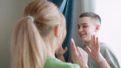 Close up matron finds younger hiding behind curtain, gently taps nose, playful surprise softens into warm hug near window, light curtain movement adds tenderness to indoor family bonding moment