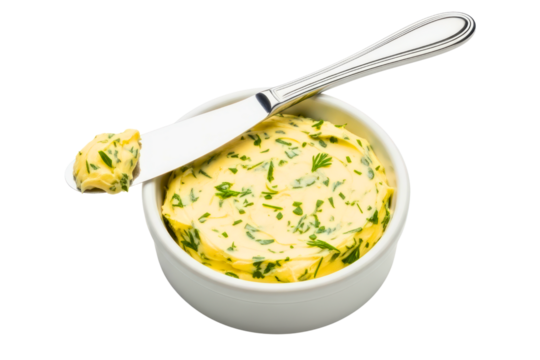 White bowl of fresh herb butter with a silver spreader knife isolated on transparent background