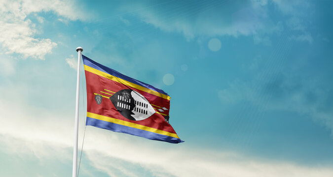 Eswatini national flag fluttering. The flag blowing in beautiful soft sky. Eswatini national flag for independence day. - Powered by Adobe