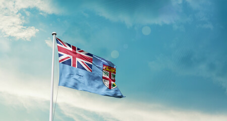Fiji national flag fluttering. The flag blowing in beautiful soft sky. Fiji national flag for independence day.