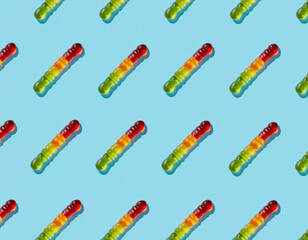 Seamless Pattern of Colorful Gummy Worm Candies on Blue Background