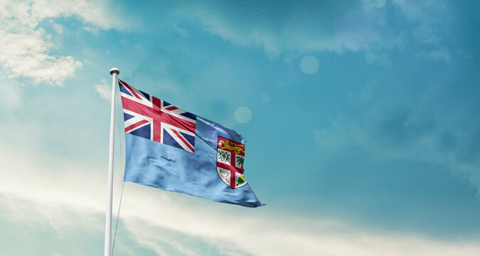 Fiji national flag fluttering. The flag blowing in beautiful soft sky. Fiji national flag for independence day.