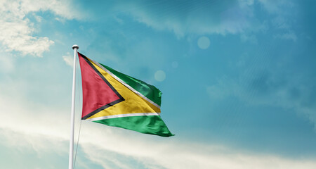 Guyana national flag fluttering. The flag blowing in beautiful soft sky. Guyana national flag for independence day.