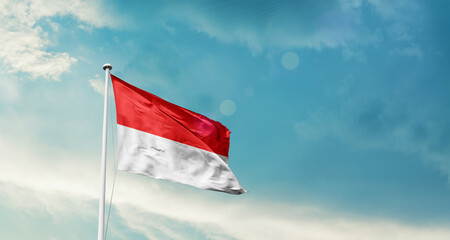 Indonesia national flag fluttering. The flag blowing in beautiful soft sky. Indonesia national flag for independence day.