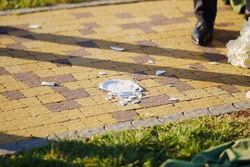 Plate shatters on path during outdoor wedding ceremony