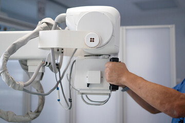 Radiologist operating x-ray machine for medical diagnosis