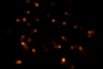 Golden blurred bokeh lights on black background. Glitter sparkle stars for celebrate. Overlay for your design. Bokeh effect golden light background. Golden Christmas concept. yellow sparkling bokeh
