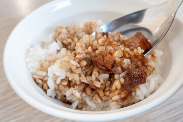 Braised pork belly meat over cooked rice.