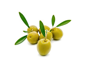 green olives with green leaves isolated on white background.