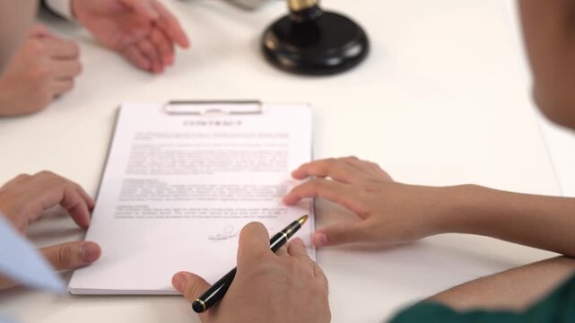 Couples legal file for divorcing by assistance from law firm to divide property after breakup. Obligations contract assist by lawyer in negotiating settlement agreement meeting. Slow motion. Rigid.