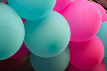 Colorful pastel balloons background in pink and blue tones. Festive party decoration for birthday, baby shower, or gender reveal celebration. Minimal soft composition.