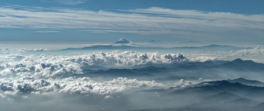 In the distance, there is an island covered in white clouds and mist floating above it, creating a dreamy atmosphere. the sky is blue with some dark grayish white clouds hanging low over mount fuji.  - Powered by Adobe