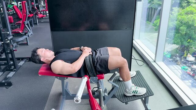 Man Performing Hip Thrust Exercise in Modern Gym Setting