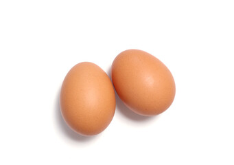 Two brown chicken eggs isolated on white background. Perfect for organic food, protein, healthy diet, and cooking concepts. Ideal for advertising, nutrition, and farm-fresh product design.