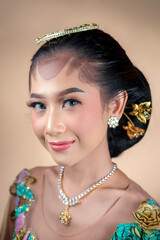 Elegant Indonesian Woman in Traditional Dress with Graceful Smile