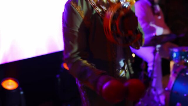 Musician performing with tambourine at outdoor event