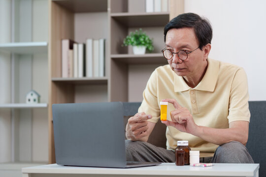 Senior man reviewing prescription medication during online consultation