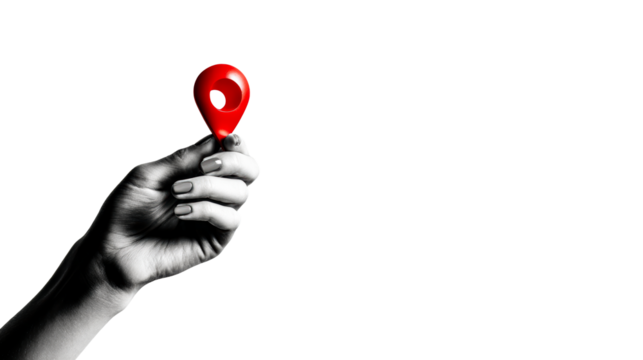 Hand holding red location pin symbol