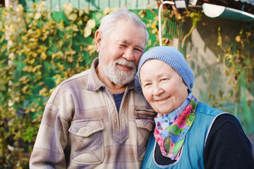 Elderly couple enjoying their garden in warm sunlight