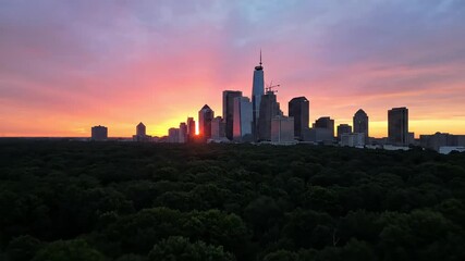Spectacular urban skyline bathed in golden light at sunrise with vibrant colors reflecting on modern skyscrapers, perfect for travel, business, or aspirational themes