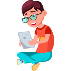 Young Boy with Glasses Enthusiastically Using a Tablet Computer Sitting Cross-legged in Casual Attire with a Blue Background