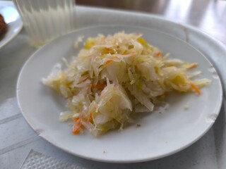 Homemade sauerkraut in a white plate.