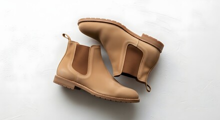 Pair of tan suede chelsea boots isolated on white background