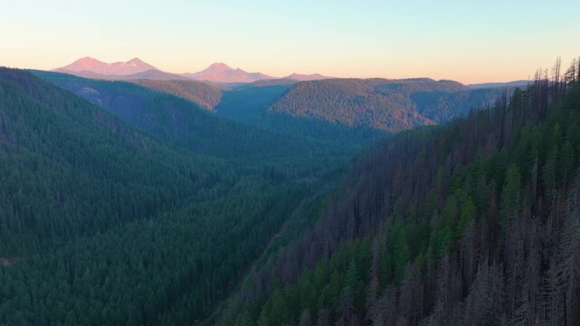 Oregon aerial drone footage showing mountain ridges and Three Sisters in the dis
