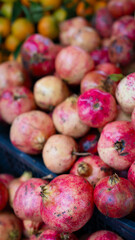 fresh red pomegranates at a market street stall