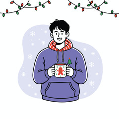 Young man wearing a hoodie holding a festive Christmas mug with a gingerbread man illustration.