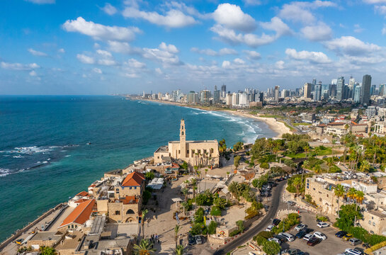 Aerial view of the striking St. Peter's Church stands majestically above the ancient port city, contrasting with the modern skyline along the Mediterranean coast, Tel Aviv-Yafo, Israel.