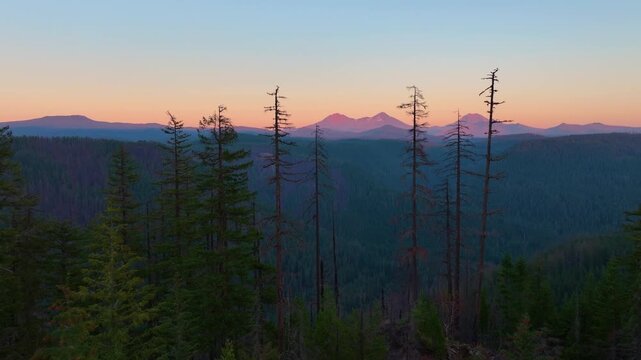 Drone footage flying over Oregon wilderness toward the Three Sisters mountains