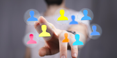 Concept of teamwork, selection, recruitment and management. Hand interacting with a digital interface of people icons. Networking and connection