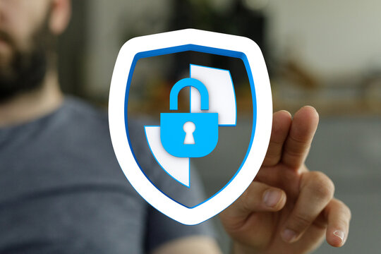 Concept of cybersecurity protection and data privacy with a man's hand touching the security shield with lock icon - Powered by Adobe