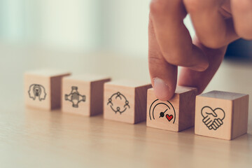 Soft skills and emotional intelligence development in leadership. Wooden blocks with soft skills icons such as empathy, communication, teamwork and emotional intelligence  in workplace.