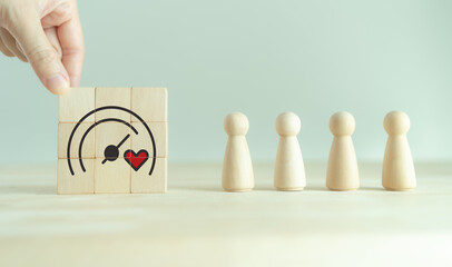 Soft skills and emotional intelligence in business leadership. Wooden blocks with heart and gauge icons, symbolizing soft skills, empathy, emotional intelligence and balanced business performance.