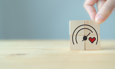 Soft skills and emotional intelligence in business leadership. Wooden blocks with heart and gauge icons, symbolizing soft skills, empathy, emotional intelligence and balanced business performance.