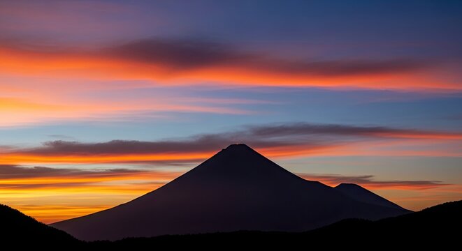 Stunning volcanic silhouette against vibrant sunset sky, a breathtaking landscape for travel inspiration and adventure seekers, perfect for nature blogs