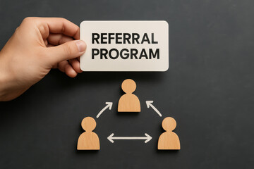 Hand holding referral program sign over network diagram. business marketing incentive for customer growth and strategy