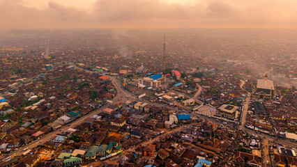 Aerial view of the city's heart, where buildings cluster and roads converge under a hazy sky, creating a tapestry of urban life, Ibadan, Oyo, Nigeria.