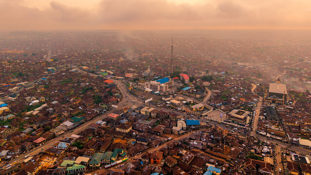 Aerial view of the city's heart, where buildings cluster and roads converge under a hazy sky, creating a tapestry of urban life, Ibadan, Oyo, Nigeria.