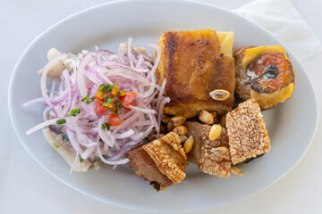 Typical Peruvian dish called Triple with ceviche, crispy pork, stuffed rocoto pepper. Close-up shot. Arequipa