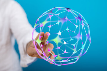 An artistic representation of a hand holding a digital sphere. This image evokes concepts of...