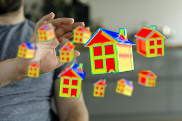 Vibrant image of a hand holding stylized houses symbolizing real estate, mortgage, and property...