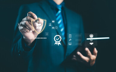 Businessman touching digital security shield with check mark, representing data protection, cybersecurity, privacy, and online safety assurance in modern business technology concept.