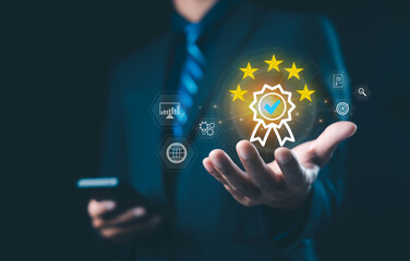 Businessman holding digital five-star quality assurance badge, symbolizing trust, certification, excellence, and professional service in modern technology and online business management concept.